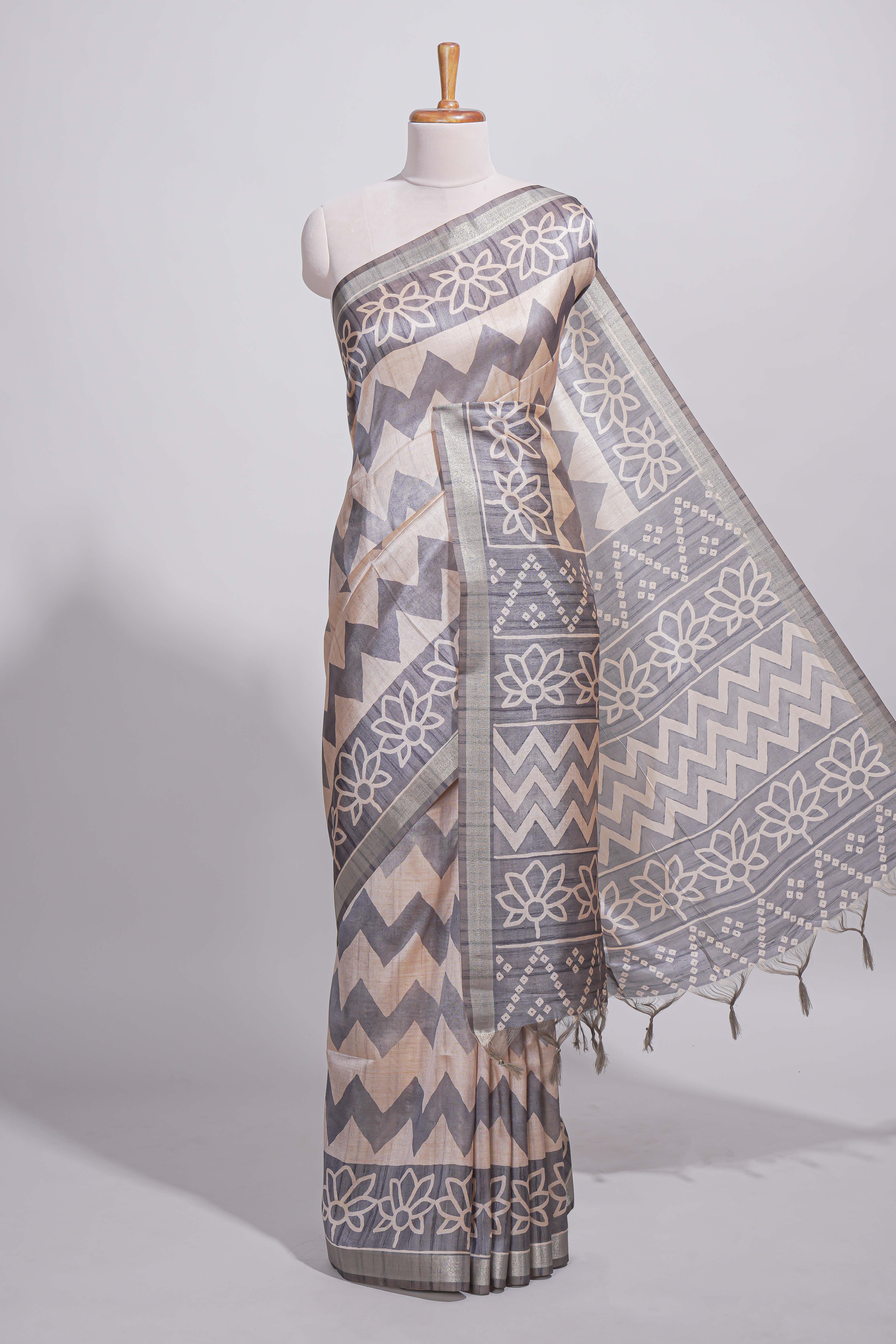 Grey and ivory color tussar saree body chevron prints floral motifs and printed pallu along with matching blouse