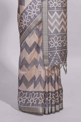 Grey and ivory color tussar saree body chevron prints floral motifs and printed pallu along with matching blouse