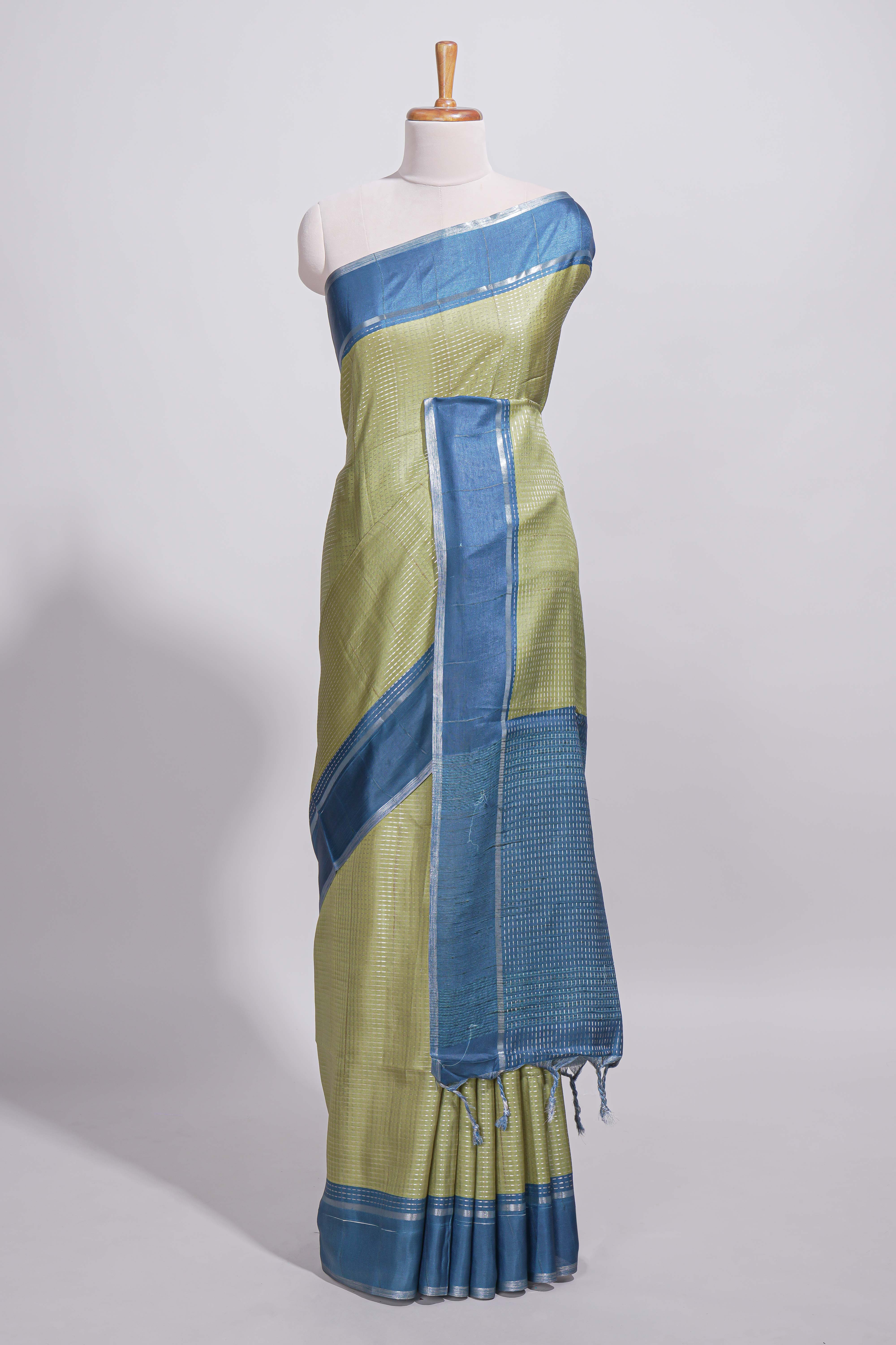 Green tussar saree with woven checks by rich blue border and matching zari woven pallu with contrast blouse piece