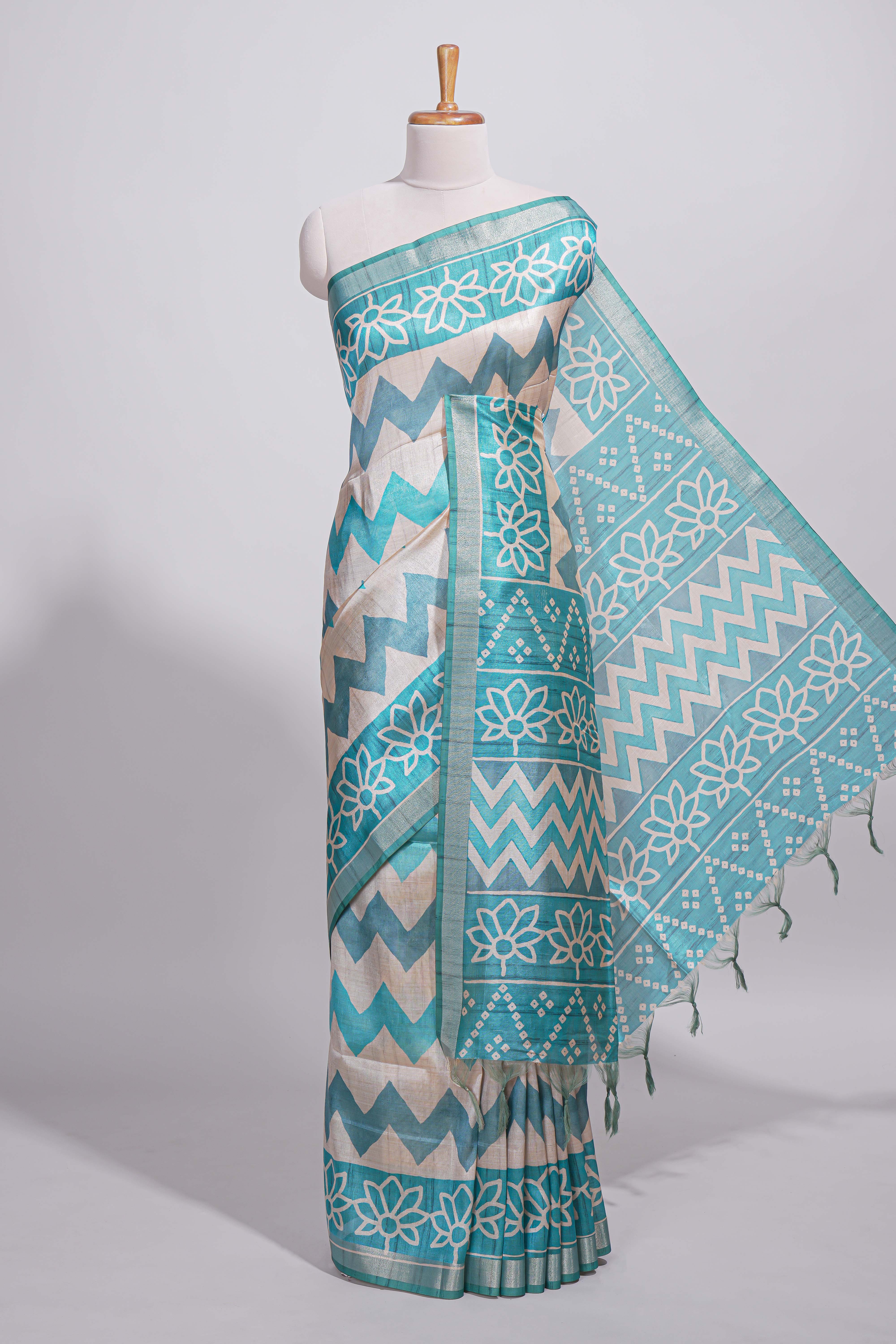 Turquoise color tussar saree body chevron prints floral motifs and printed pallu along with matching blouse