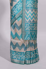 Turquoise color tussar saree body chevron prints floral motifs and printed pallu along with matching blouse