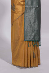 Mustard yellow tussar saree with subtle silver woven motifs paired with a rich zari pallu with tassels with contrast blouse piece
