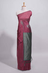 Maroon tussar saree with subtle silver woven motifs paired with a rich zari pallu with tassels with contrast blouse piece