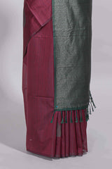 Maroon tussar saree with subtle silver woven motifs paired with a rich zari pallu with tassels with contrast blouse piece