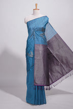 Royal blue tussar saree with subtle silver woven motifs paired with a rich zari pallu with tassels with contrast blouse piece