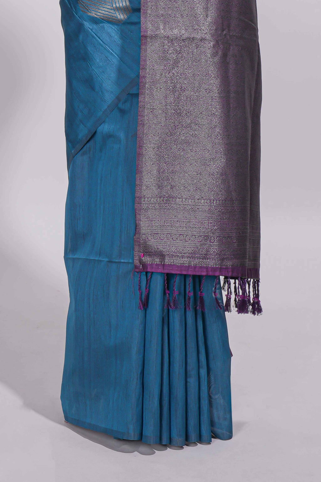 Royal blue tussar saree with subtle silver woven motifs paired with a rich zari pallu with tassels with contrast blouse piece