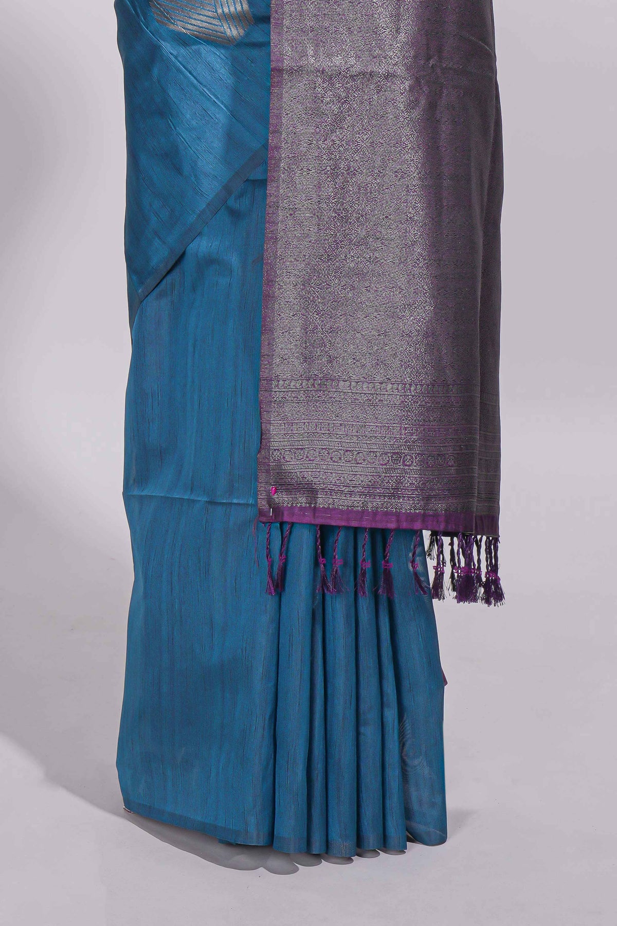 Royal blue tussar saree with subtle silver woven motifs paired with a rich zari pallu with tassels with contrast blouse piece