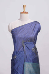 Navy blue tussar saree with subtle silver woven motifs paired with a rich zari pallu with tassels with contrast blouse piece