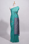 Peacock green tussar saree with subtle silver woven motifs paired with a rich zari pallu with tassels with contrast blouse piece