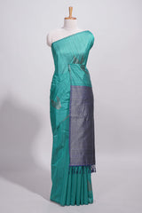 Peacock green tussar saree with subtle silver woven motifs paired with a rich zari pallu with tassels with contrast blouse piece