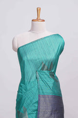 Peacock green tussar saree with subtle silver woven motifs paired with a rich zari pallu with tassels with contrast blouse piece