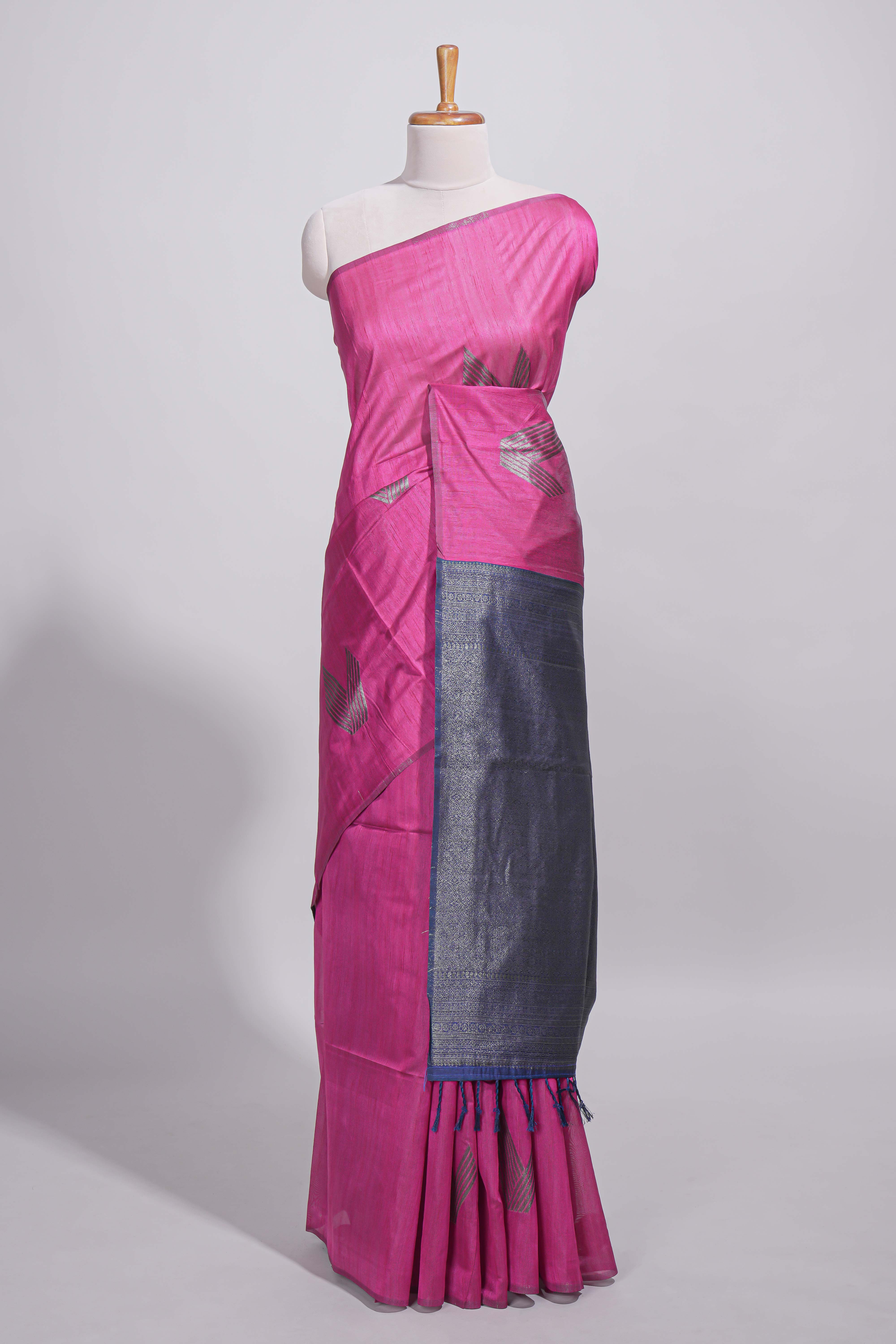 Rose color tussar saree with subtle silver woven motifs paired with a rich zari pallu with tassels with contrast blouse piece
