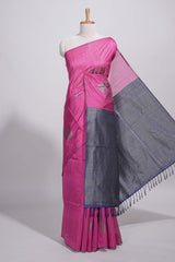 Rose color tussar saree with subtle silver woven motifs paired with a rich zari pallu with tassels with contrast blouse piece