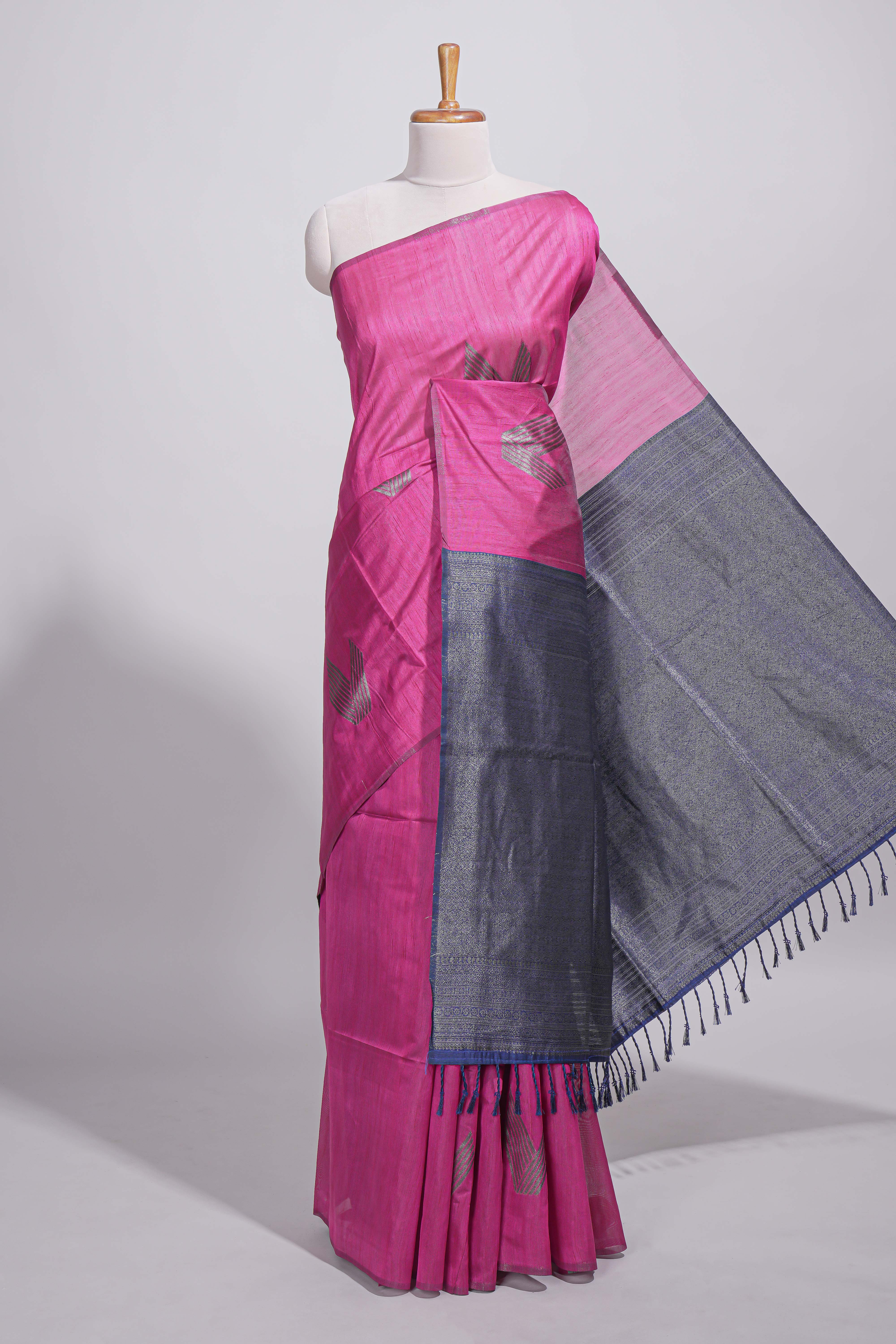 Rose color tussar saree with subtle silver woven motifs paired with a rich zari pallu with tassels with contrast blouse piece
