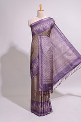 Dark beige geometric motifs art tussar saree with contrast border and striped blouse