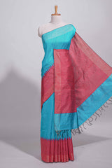 Aqua blue Tussar saree with magenta zari woven border and contrast pallu with matching magenta blouse