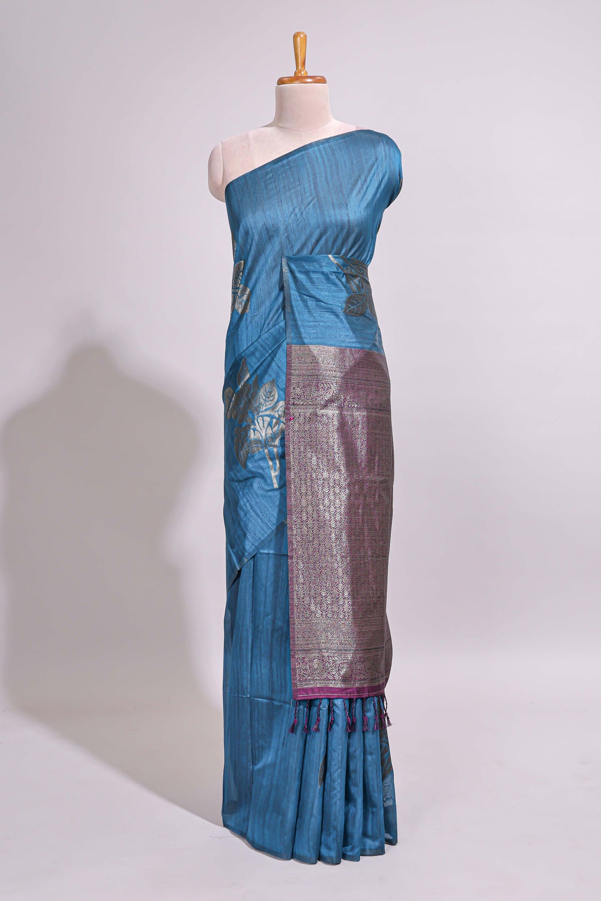 Borderless floral design blue art tussar saree with contrast pallu and silver motifs blouse