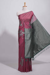 Dark maroon color tussar saree with subtle silver woven motifs paired with a rich zari pallu with tassels with contrast blouse piece