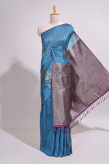 Borderless floral design blue art tussar saree with contrast pallu and silver motifs blouse