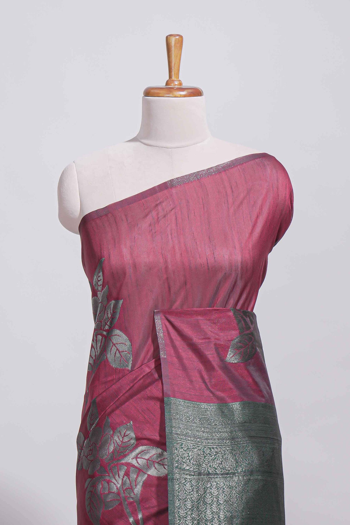 Dark maroon color tussar saree with subtle silver woven motifs paired with a rich zari pallu with tassels with contrast blouse piece