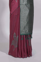Dark maroon color tussar saree with subtle silver woven motifs paired with a rich zari pallu with tassels with contrast blouse piece