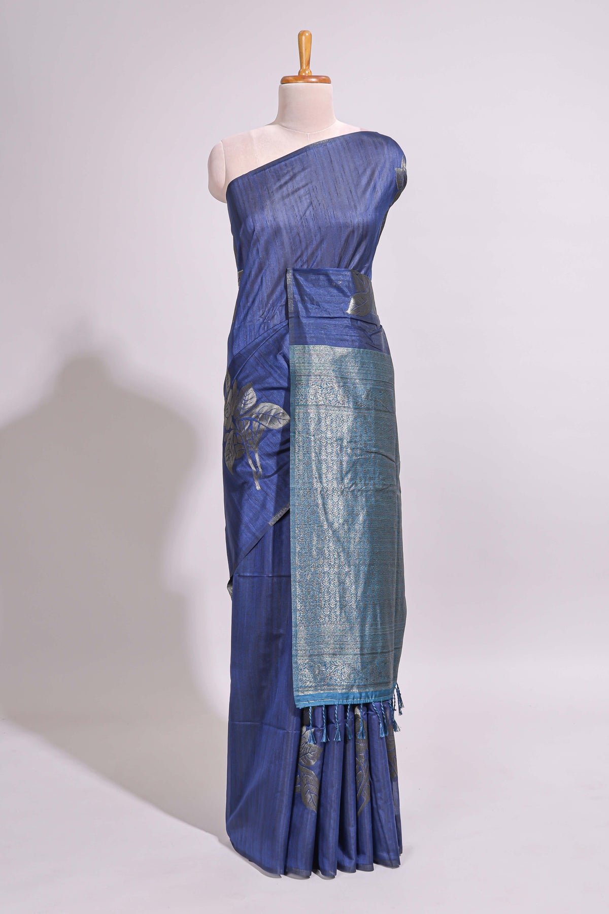 Borderless floral design blue art tussar saree with contrast pallu and silver motifs blouse