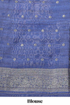 Borderless floral design green art tussar saree with contrast pallu and silver motifs blouse