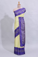 Pale yellow geometric zari butta art tussar saree with contrast zari border and striped blouse