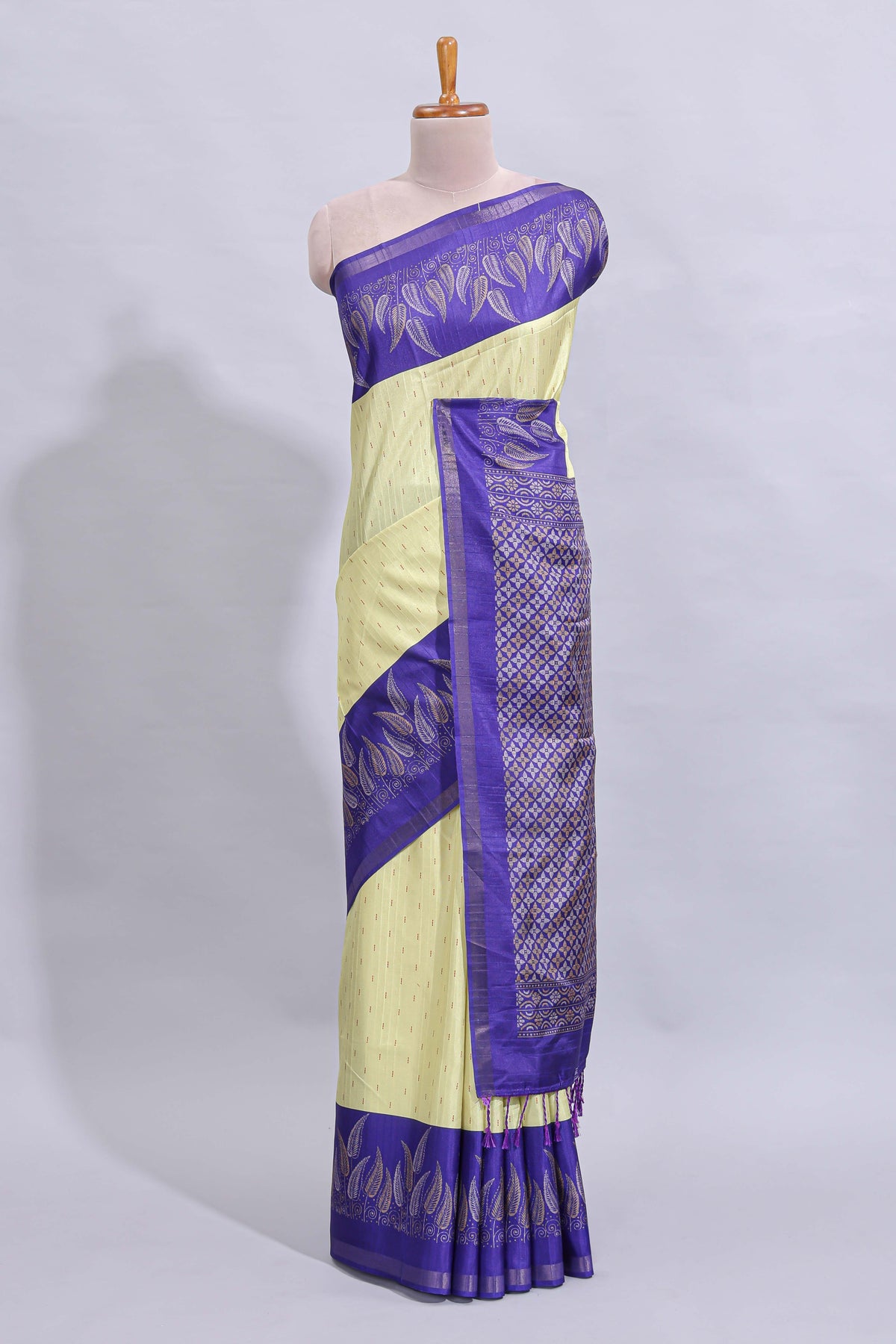 Pale yellow geometric zari butta art tussar saree with contrast zari border and striped blouse