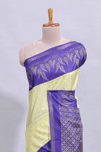 Pale yellow geometric zari butta art tussar saree with contrast zari border and striped blouse