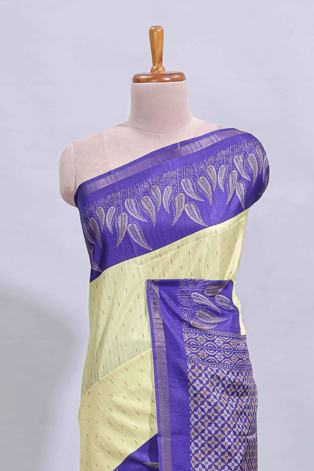 Pale yellow geometric zari butta art tussar saree with contrast zari border and striped blouse