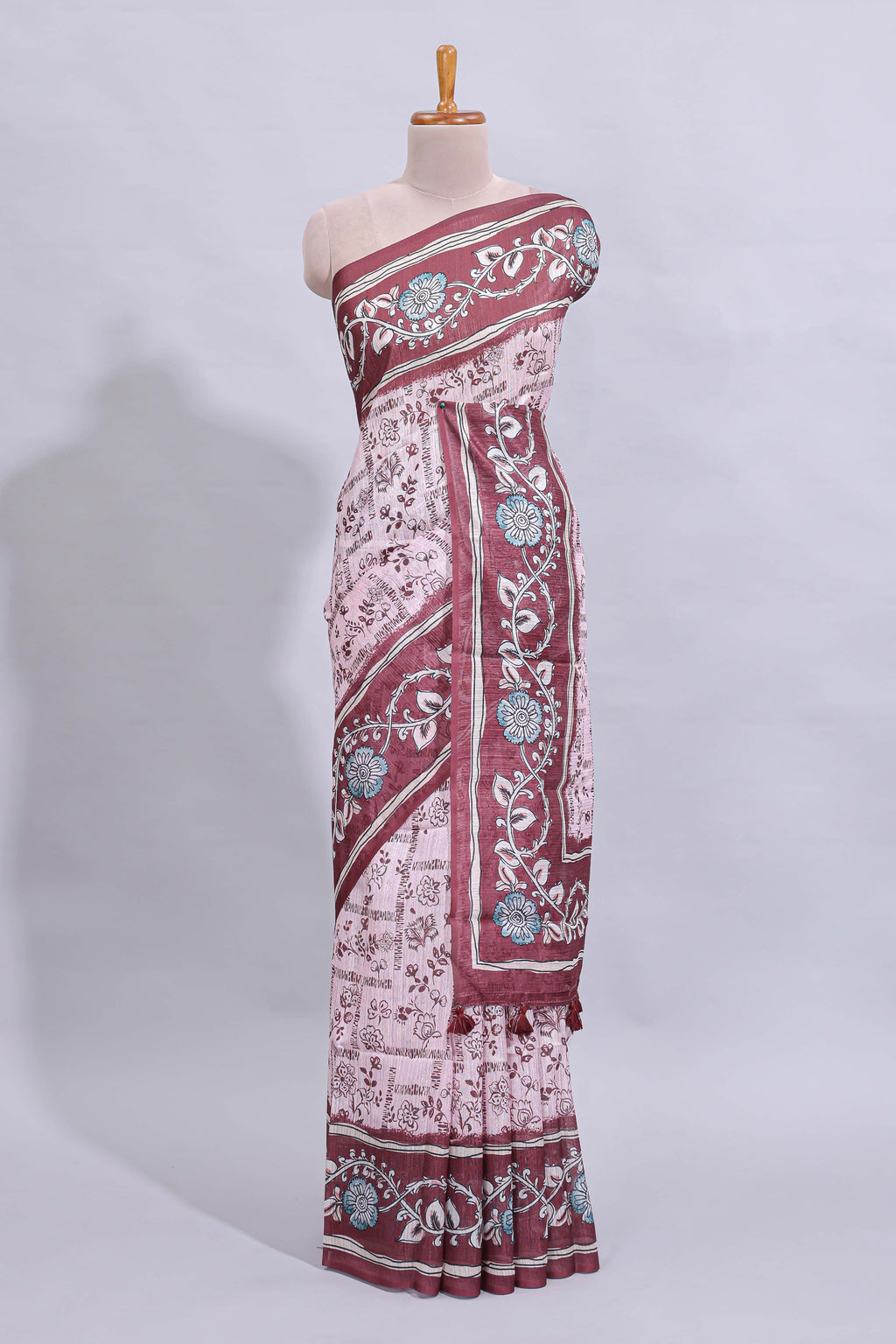 Pale pink floral design art tussar saree with contrast border and matching motifs blouse