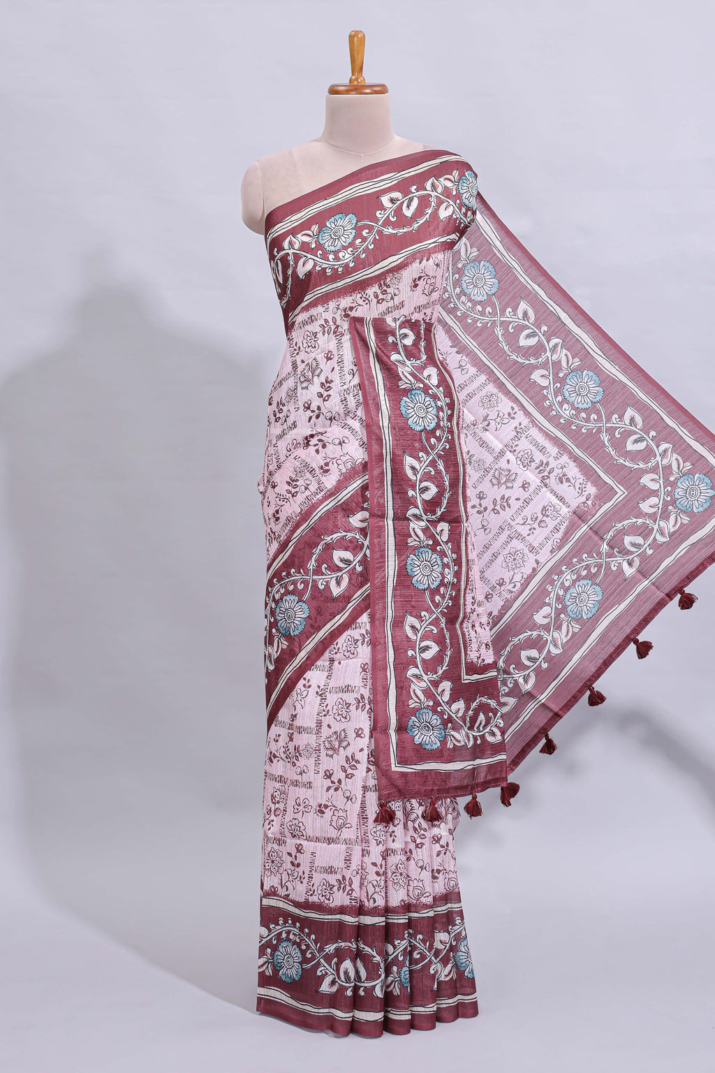 Pale pink floral design art tussar saree with contrast border and matching motifs blouse