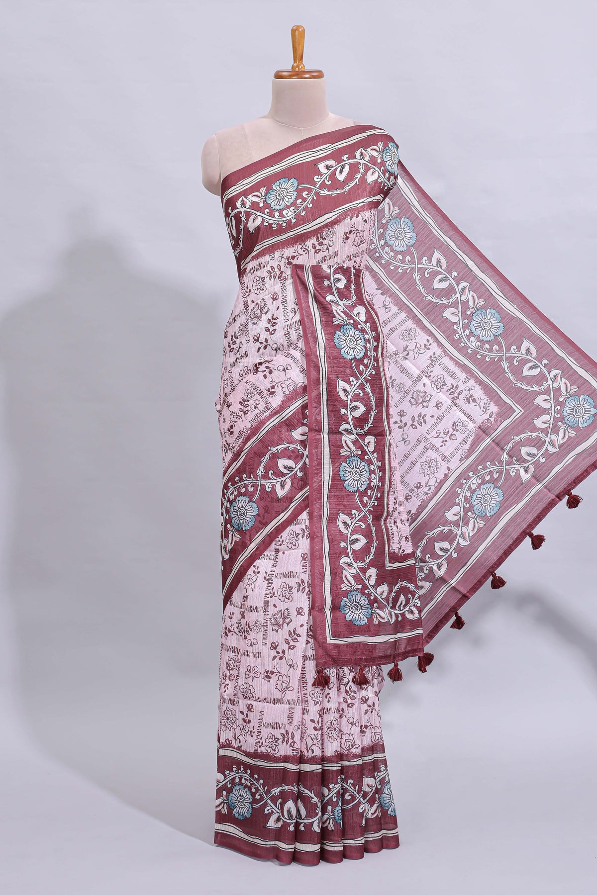 Pale pink floral design art tussar saree with contrast border and matching motifs blouse