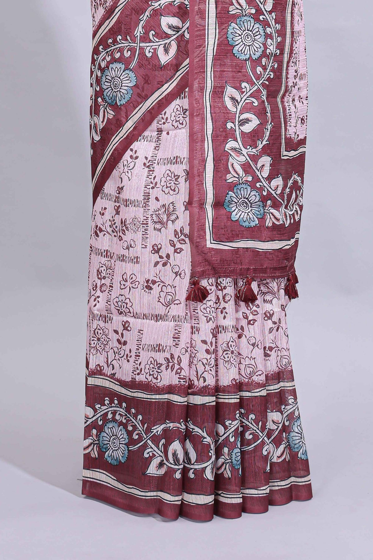 Pale pink floral design art tussar saree with contrast border and matching motifs blouse
