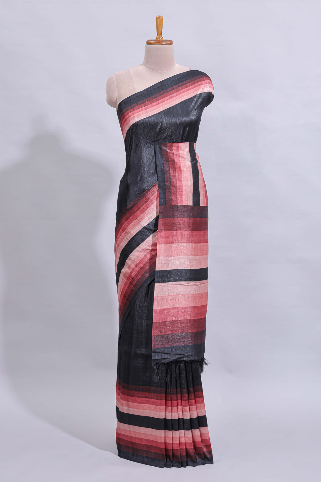 Black textured plain art tussar saree with contrast pink border and matching striped blouse