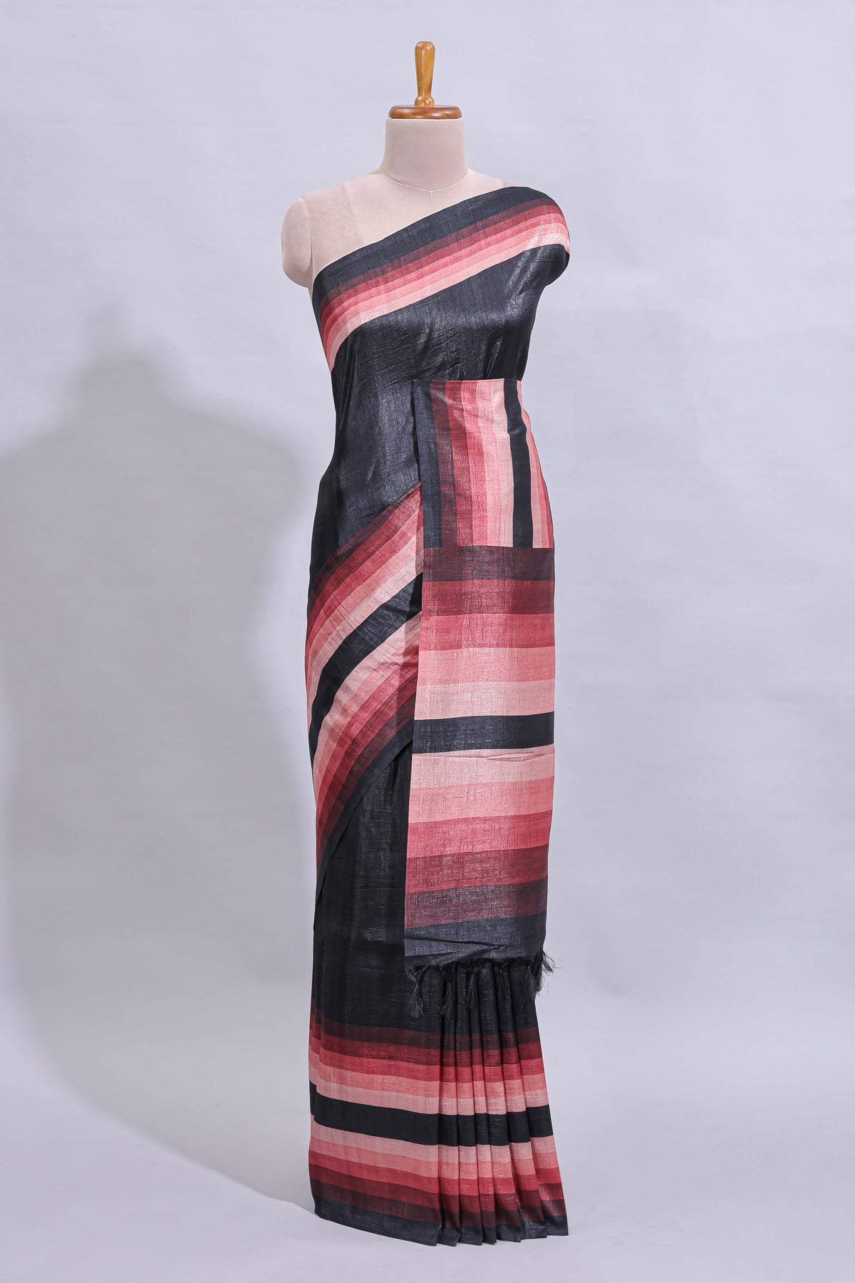 Black textured plain art tussar saree with contrast pink border and matching striped blouse
