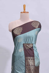 Powder blue floral motifs art tussar saree with contrast zari border and plain blouse