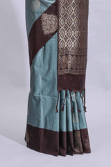 Powder blue floral motifs art tussar saree with contrast zari border and plain blouse