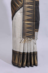 Light grey checked art tussar saree with contrast temple zari border and striped blouse