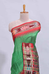 Green plain art tussar saree with contrast ikkat style border and floral design striped pallu