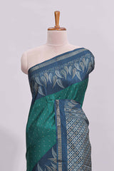 Green motifs art tussar saree with contrast leaf design border and striped blouse