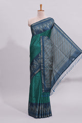 Green motifs art tussar saree with contrast leaf design border and striped blouse