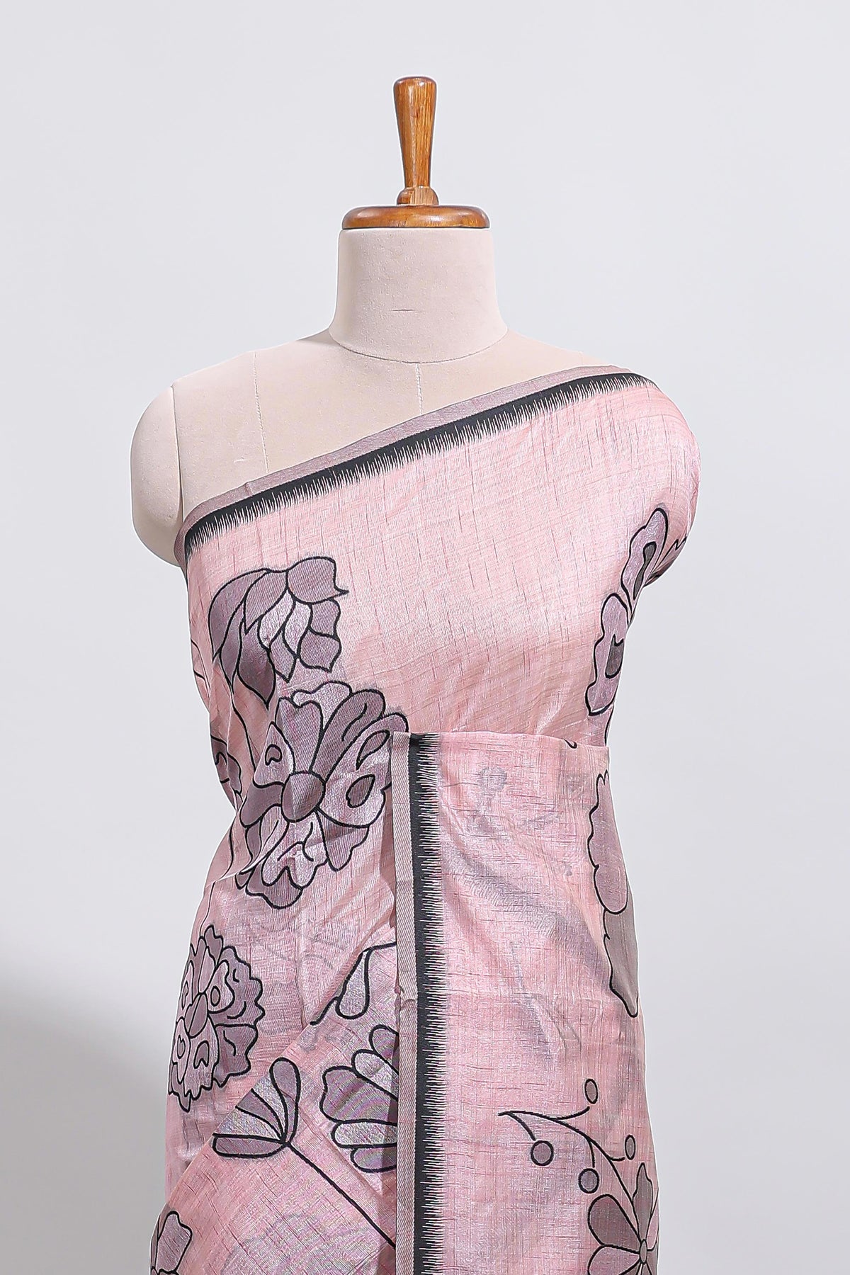 Blush pink with charcoal grey floral print tussar saree with self sleek serrated border and matching blouse