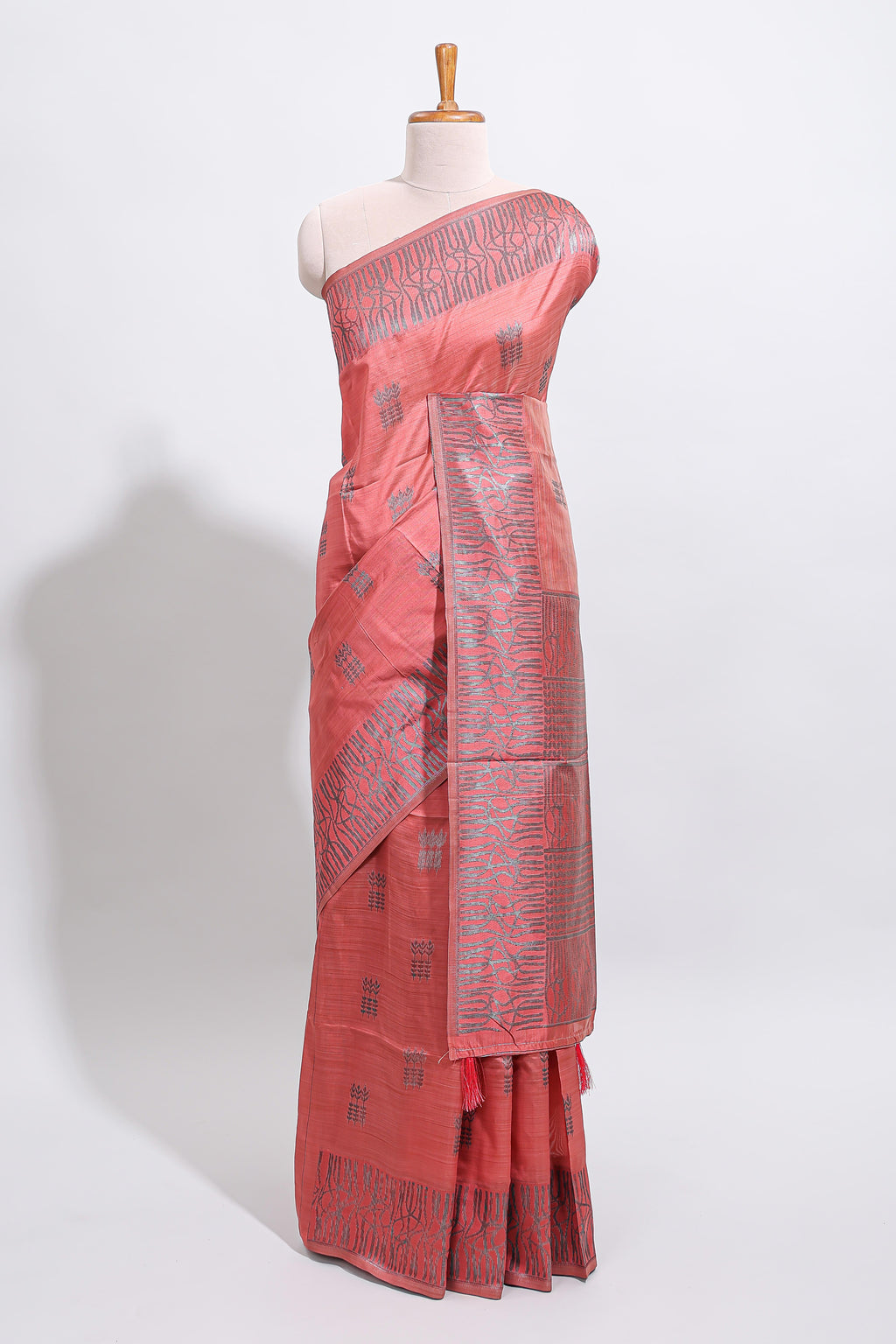Coral rust geometric matrix tussar saree with self tangled branchesborder and pallu with matching blouse