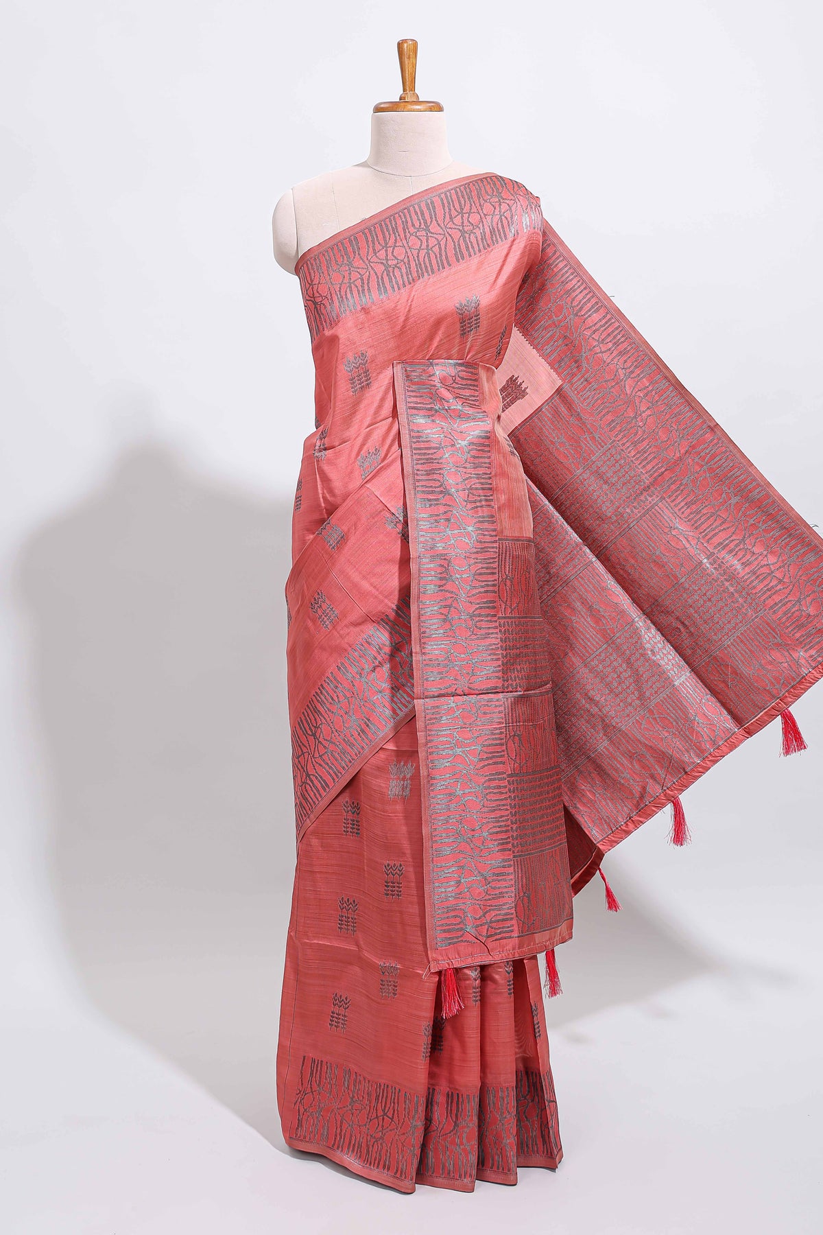 Coral rust geometric matrix tussar saree with self tangled branchesborder and pallu with matching blouse