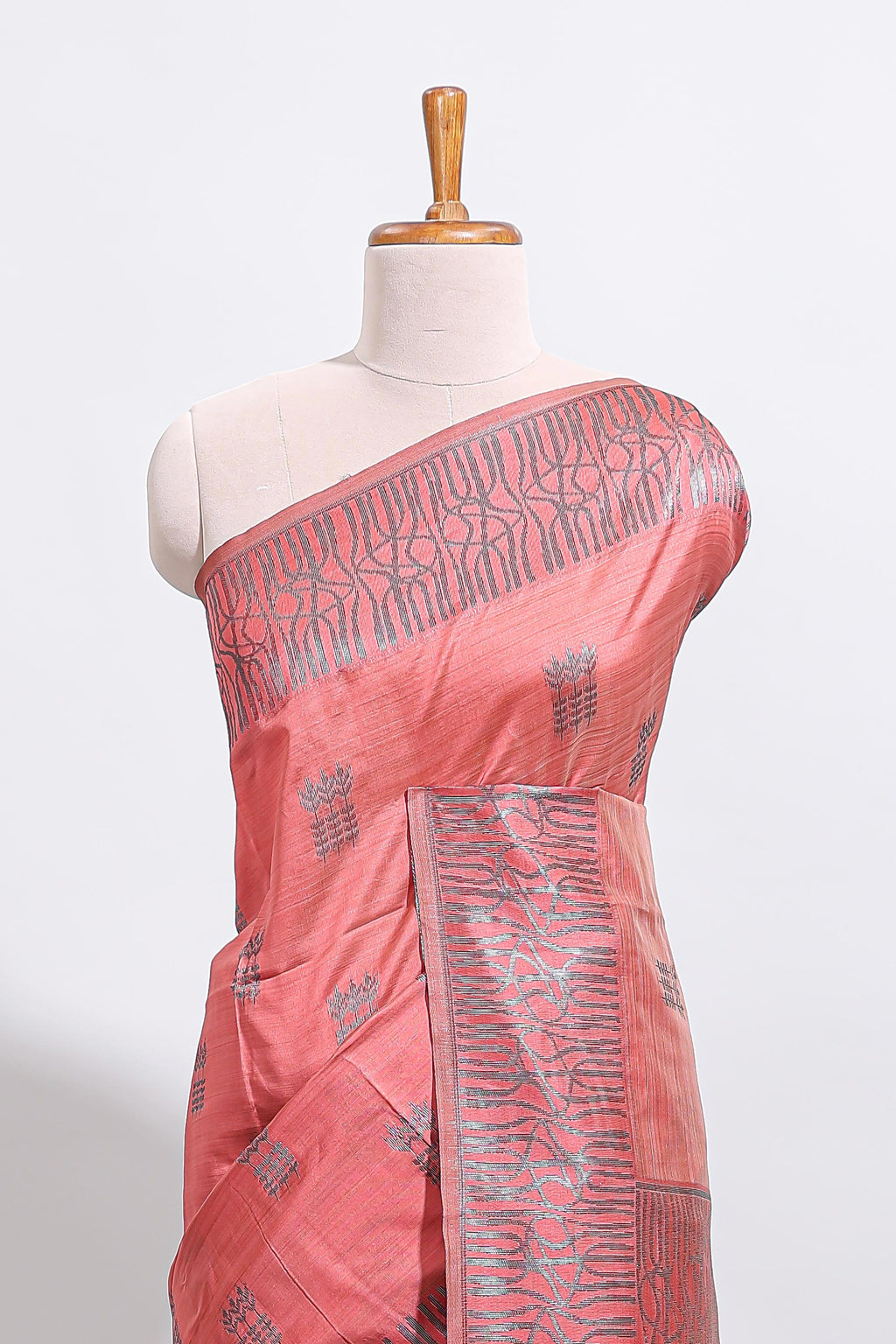 Coral rust geometric matrix tussar saree with self tangled branchesborder and pallu with matching blouse