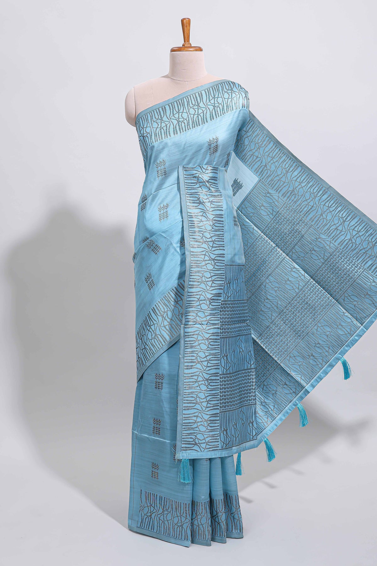 Light blue geometric matrix tussar saree with self tangled branchesborder and pallu with matching blouse