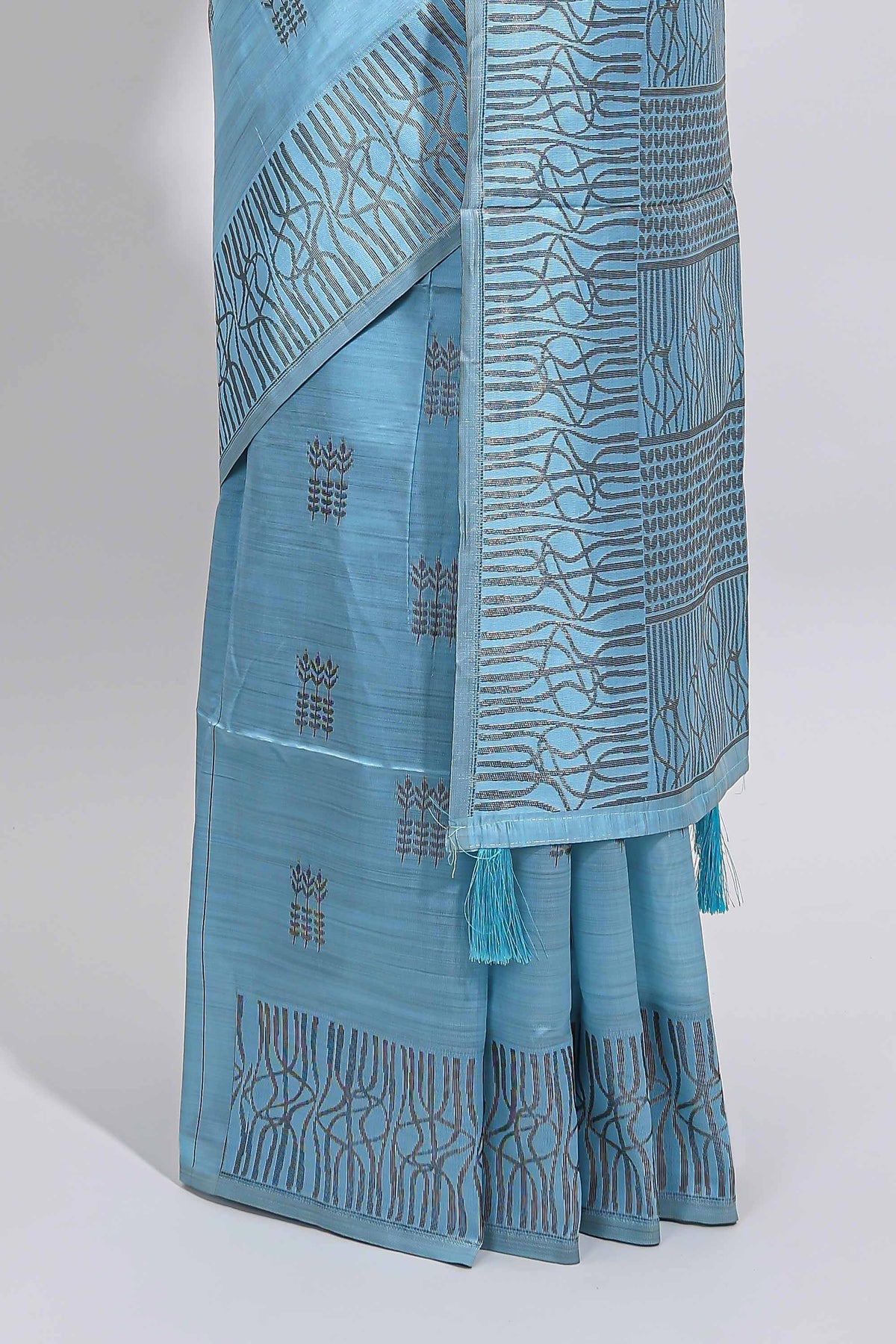 Light blue geometric matrix tussar saree with self tangled branchesborder and pallu with matching blouse