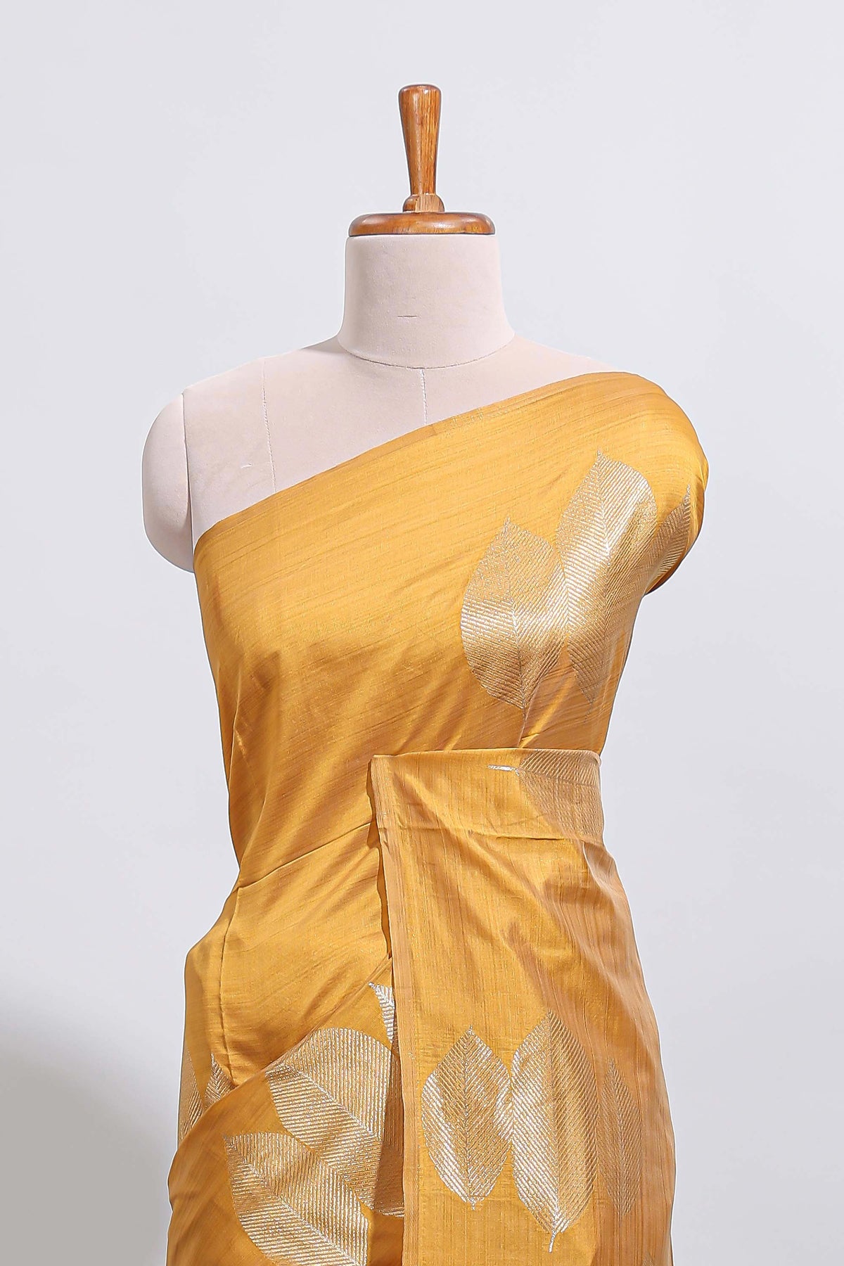 Borderless mustard yellow monochrome leafy motifs tussar saree with matching blouse